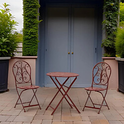 Aubry Gaspard Table et chaises de jardin en métal laqué rouge rouge antique.